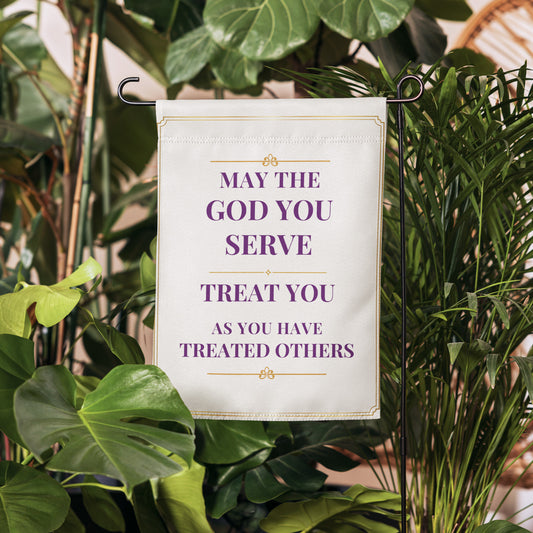 May the God You Serve inspirational garden flag displayed in a garden
